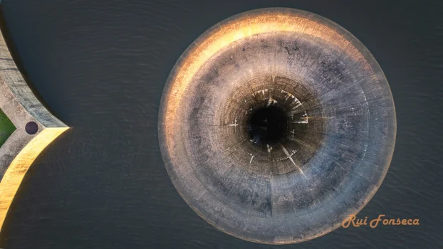 Aerial view of the Albufeira Water Tank in Portugal, showcasing its circular design and surrounding landscape.