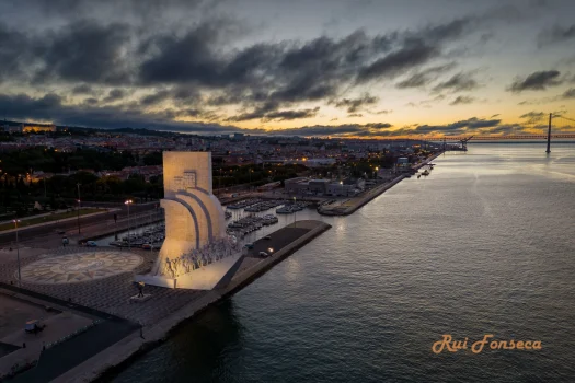 Aerial view of the Monument to the Discoveries in Lisbon, Portugal at dusk.
