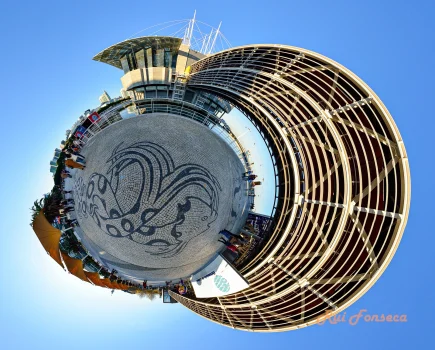 A fisheye view of the Porto Maritime Station in Porto, Portugal, with people milling about and a clear blue sky overhead.