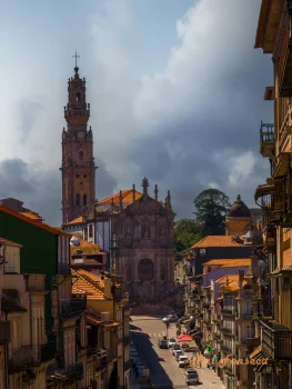 A wide-angle view of Braga, Portugal, showcasing the Braga Cathedral (Sé de Braga) with its prominent baroque tower, framed by traditional buildings and a street scene.