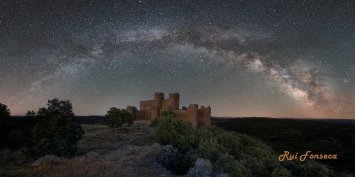 Night photography of a medieval castle under a starry sky